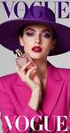 A fashion model holding a perfume bottle, wearing a large-brimmed purple hat and vibrant magenta clo